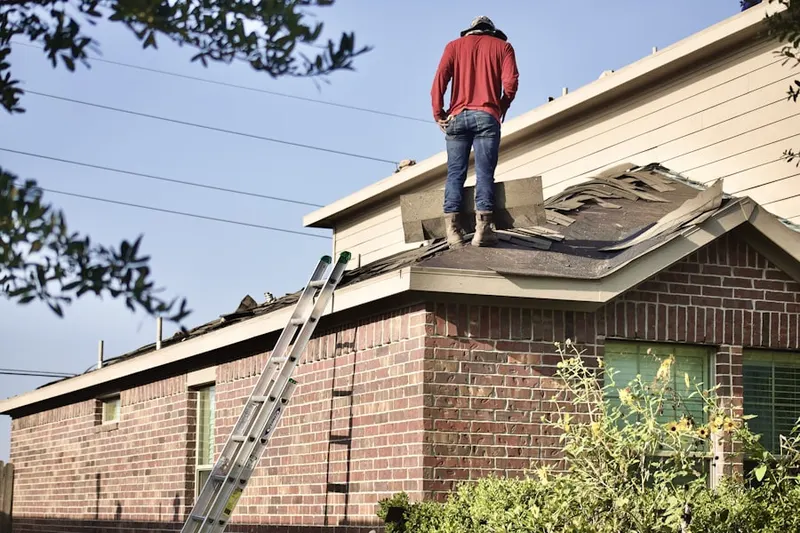 Professional roofer working on a residential roof in Sunset Fields